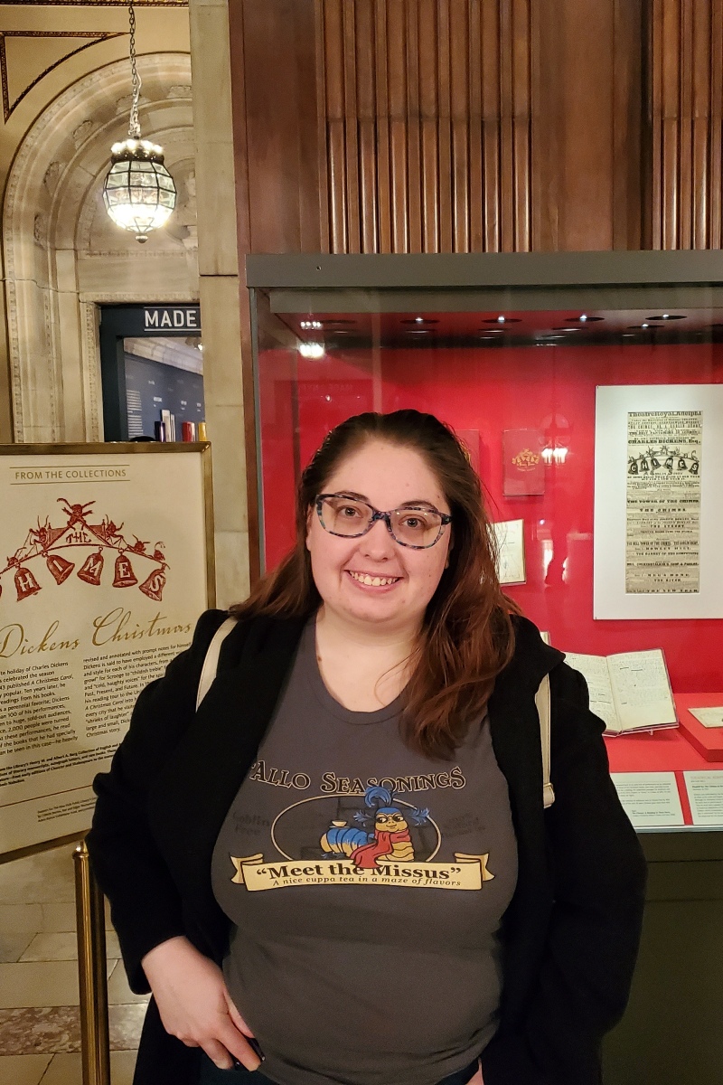 Cassi in front of a display on Charles Dickens' A Christmas Carol